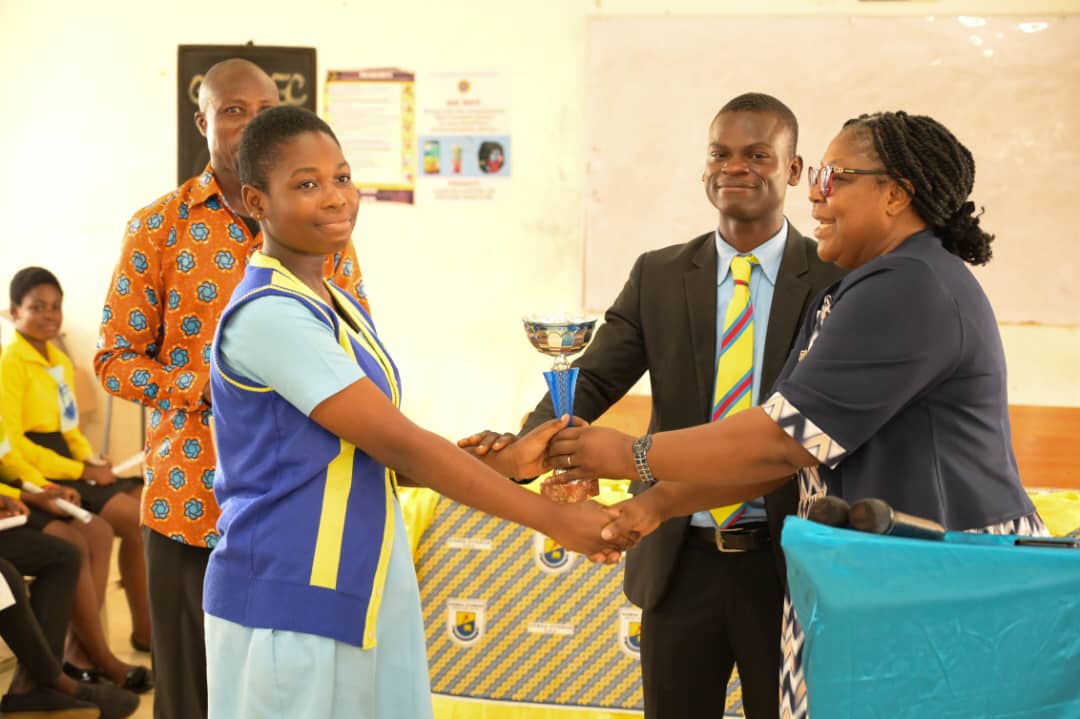 A student receiving a trophy at the prize presentation