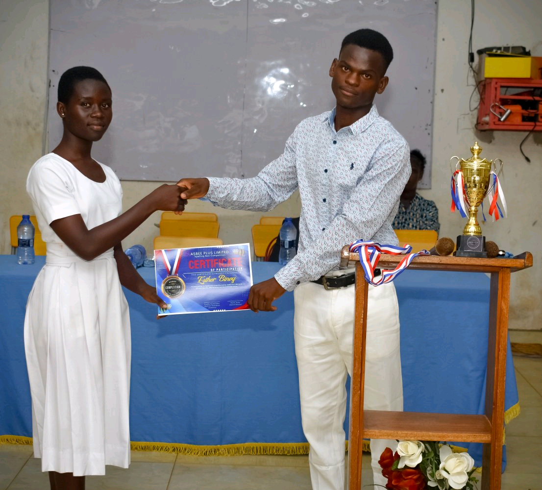 A contestant receiving her certificate of participation